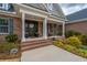 Charming brick front porch features classic columns, rocking chairs, and professionally landscaped front yard at 105 Pine Valley Dr, Summerville, SC 29483
