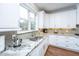 Kitchen with granite counters, stainless steel sink, and white cabinets providing a clean, modern look at 105 Pine Valley Dr, Summerville, SC 29483
