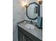 Charming powder room featuring stylish wallpaper, elegant mirror, and modern vanity at 105 Pine Valley Dr, Summerville, SC 29483