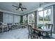 Bright sunroom filled with natural light, tile floors, and comfortable furniture with backyard views at 105 Pine Valley Dr, Summerville, SC 29483