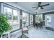 Inviting sunroom with large windows offering scenic views, tile floors, and a cozy seating area at 105 Pine Valley Dr, Summerville, SC 29483