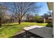 Expansive backyard with a mix of grass, concrete, and a shed for outdoor storage at 109 Arbor Oaks Dr, Summerville, SC 29485