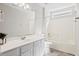Bright bathroom features a white vanity, large mirror, tub, and neutral-toned floor at 109 Arbor Oaks Dr, Summerville, SC 29485