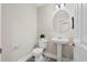 Powder room featuring a pedestal sink, oval mirror, and wood-look flooring at 109 Arbor Oaks Dr, Summerville, SC 29485