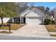 This charming one-story home has a paved driveway and a manicured lawn at 109 Arbor Oaks Dr, Summerville, SC 29485