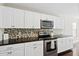 Well-lit kitchen with stainless steel oven and microwave, mosaic backsplash, and dark countertops at 109 Arbor Oaks Dr, Summerville, SC 29485