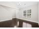 Cozy living room featuring hardwood floors, bright window, and staircase at 109 Arbor Oaks Dr, Summerville, SC 29485