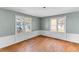 Bright bedroom with hardwood floors and two windows, offering plenty of natural light at 1124 Berkeley St, Hanahan, SC 29410