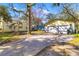 Charming yellow home with a two-car garage and a spacious driveway on a sunny day at 1124 Berkeley St, Hanahan, SC 29410