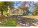 Charming two-story yellow house with a well-maintained lawn and surrounded by mature trees at 1124 Berkeley St, Hanahan, SC 29410