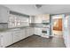 Bright kitchen with white cabinets, appliances, and ample counter space at 1124 Berkeley St, Hanahan, SC 29410