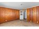 Wood-paneled room with an open doorway leading to the kitchen at 1124 Berkeley St, Hanahan, SC 29410