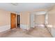 Peach room with stained carpet and a doorway to another room at 1124 Berkeley St, Hanahan, SC 29410