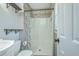 Cozy bathroom featuring a shower with white tiling and a patterned shower curtain, sink, and toilet at 114 Merrimack Blvd, Moncks Corner, SC 29461