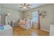 Cozy bedroom featuring a large window, pink accents, and hardwood floors at 114 Merrimack Blvd, Moncks Corner, SC 29461