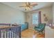 Neutral Bedroom with hardwood floors, blue crib, and chair at 114 Merrimack Blvd, Moncks Corner, SC 29461