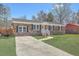Charming brick home with well-manicured lawn, complemented by a bright yellow front door at 114 Merrimack Blvd, Moncks Corner, SC 29461