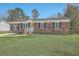 Charming brick home with black shutters, complimented by lush green lawn at 114 Merrimack Blvd, Moncks Corner, SC 29461