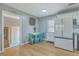 Eat-in kitchen area with modern white cabinets, stainless refrigerator, and a cozy dining space at 114 Merrimack Blvd, Moncks Corner, SC 29461