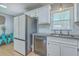 Bright kitchen with stainless steel appliances, white cabinets, and hardwood floors at 114 Merrimack Blvd, Moncks Corner, SC 29461
