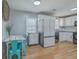 Bright kitchen featuring stainless steel appliances, white cabinets, and a breakfast nook with wooden floors at 114 Merrimack Blvd, Moncks Corner, SC 29461