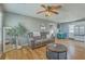 Bright living room with a plush sofa, round coffee table, and a glimpse into the kitchen at 114 Merrimack Blvd, Moncks Corner, SC 29461