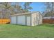 Spacious backyard featuring a shed with two garage doors, perfect for storage or a workshop space at 114 Merrimack Blvd, Moncks Corner, SC 29461