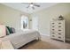Bedroom with a white wooden dresser, ceiling fan, and light filtering window at 127 Garden Gate Way, Summerville, SC 29486