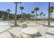 Outdoor community space with tables, chairs and palm trees near the pool at 127 Garden Gate Way, Summerville, SC 29486