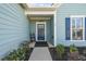 Inviting entrance with a stylish blue door, enhanced by tasteful landscaping and a charming, ladder detail at 127 Garden Gate Way, Summerville, SC 29486