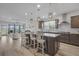 Stylish kitchen with a central island, pendant lighting, stainless steel appliances, and an open view to the living area at 127 Garden Gate Way, Summerville, SC 29486