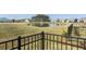 Scenic community pond with a fountain, visible from the backyard and framed by a black metal fence at 127 Garden Gate Way, Summerville, SC 29486