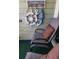 Balcony decor including a decorative wheel and anchor, along with comfortable chairs and a pillow at 1300 Ocean Blvd # 221, Isle of Palms, SC 29451