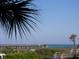 View of the pier from an ocean-view condo showing beach access and views of the Atlantic at 1300 Ocean Blvd # 221, Isle of Palms, SC 29451