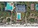 Stunning aerial view showcasing the property's pools, clubhouse, surrounded by lush greenery and beach access at 1407 Shipwatch Rd, Kiawah Island, SC 29455