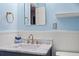 Bathroom with a marble countertop, brass fixtures, and ample lighting at 1407 Shipwatch Rd, Kiawah Island, SC 29455
