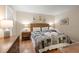 Bright bedroom showcasing a patterned bedspread, nautical art, and warm lighting at 1407 Shipwatch Rd, Kiawah Island, SC 29455