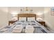 Well-lit bedroom showcasing a bed with a unique patterned coverlet and comfortable pillows at 1407 Shipwatch Rd, Kiawah Island, SC 29455