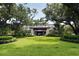 Picturesque entrance to a property, adorned with lush landscaping and mature trees at 1407 Shipwatch Rd, Kiawah Island, SC 29455