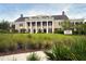 Elegant conference center with a grand entrance, manicured lawn, and mature trees at 1407 Shipwatch Rd, Kiawah Island, SC 29455