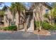 Charming exterior view of a multi-level condo with stairs leading to the entrance and mature landscaping at 1407 Shipwatch Rd, Kiawah Island, SC 29455