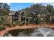 Beautiful view of condo and surrounding natural scenery from the outside, including a pond at 1407 Shipwatch Rd, Kiawah Island, SC 29455