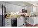 Well-equipped kitchen featuring granite countertops, stainless steel appliances, and white cabinets with a neutral backsplash at 1407 Shipwatch Rd, Kiawah Island, SC 29455