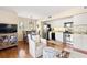 Cozy living room featuring a dining table set, a comfortable armchair, and stainless steel appliances in the kitchen at 1407 Shipwatch Rd, Kiawah Island, SC 29455