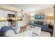 Open-concept living area with white kitchen cabinets, stainless appliances, and comfortable seating at 1407 Shipwatch Rd, Kiawah Island, SC 29455