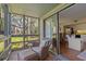 Relaxing screened-in porch featuring comfortable seating and views of lush greenery at 1407 Shipwatch Rd, Kiawah Island, SC 29455