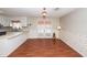 Vintage dining room features white trim, floral wallpaper, double doors, and wood-look flooring at 1452 Glencoe Dr, Mount Pleasant, SC 29464