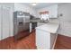 Kitchen boasts stainless steel appliances, wood floors, and white cabinetry at 1452 Glencoe Dr, Mount Pleasant, SC 29464