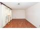 Bright, empty living room showcasing wood-look floors, neutral walls, base trim, and window with long curtains at 1452 Glencoe Dr, Mount Pleasant, SC 29464