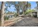 A serene backyard view features a picturesque pond surrounded by lush trees and greenery at 15 Back Ct, Isle of Palms, SC 29451